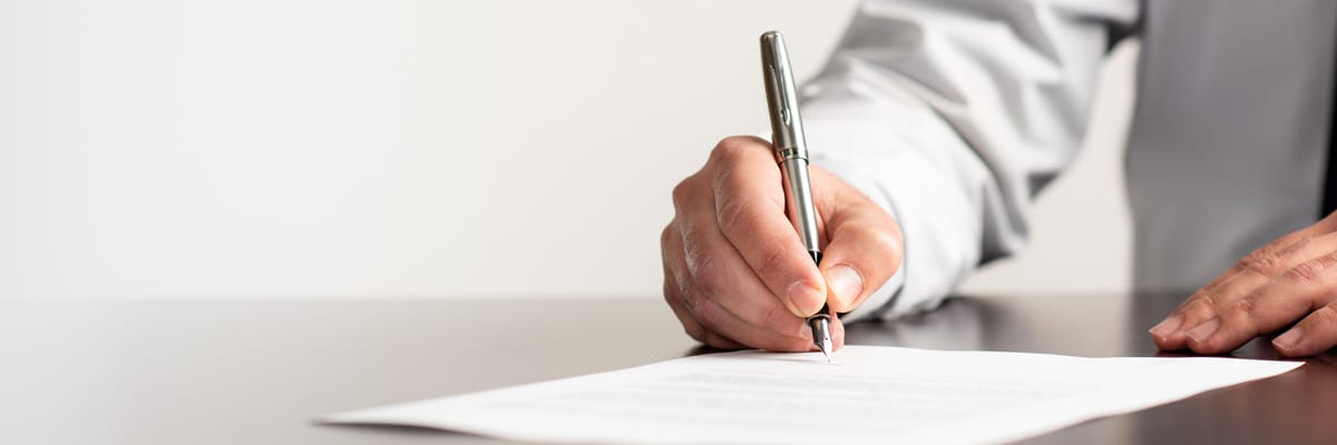 Man writing on contract